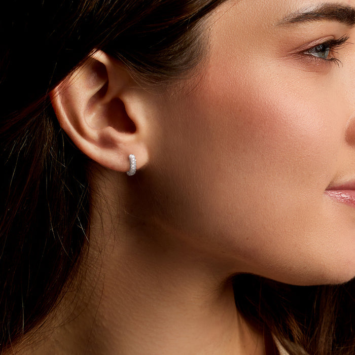 Sterling silver CZ huggie hoop earring on ear