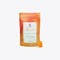 Ellevate Peach Mango low-dose THC gummies in a peach-orange stand-up pouch with a white label, shown on a light gray background with two orange gummies beside it.