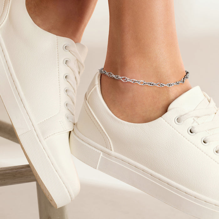 Sterling silver chain anklet on ankle, small linked pattern with secure clasp