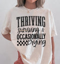 Thriving, surviving, crying ADULT TEE OR PULLOVER