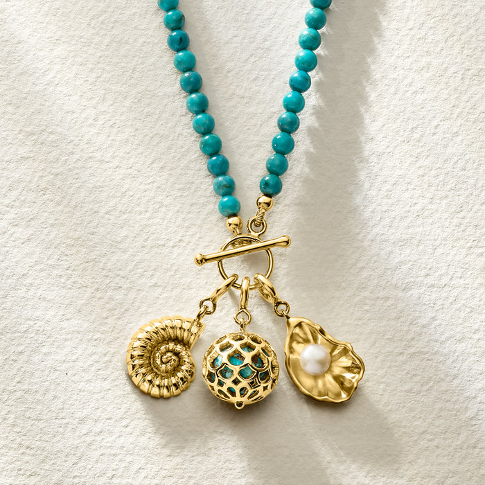 Gold turquoise scales charm with pearl-like accent and other dangling charms.